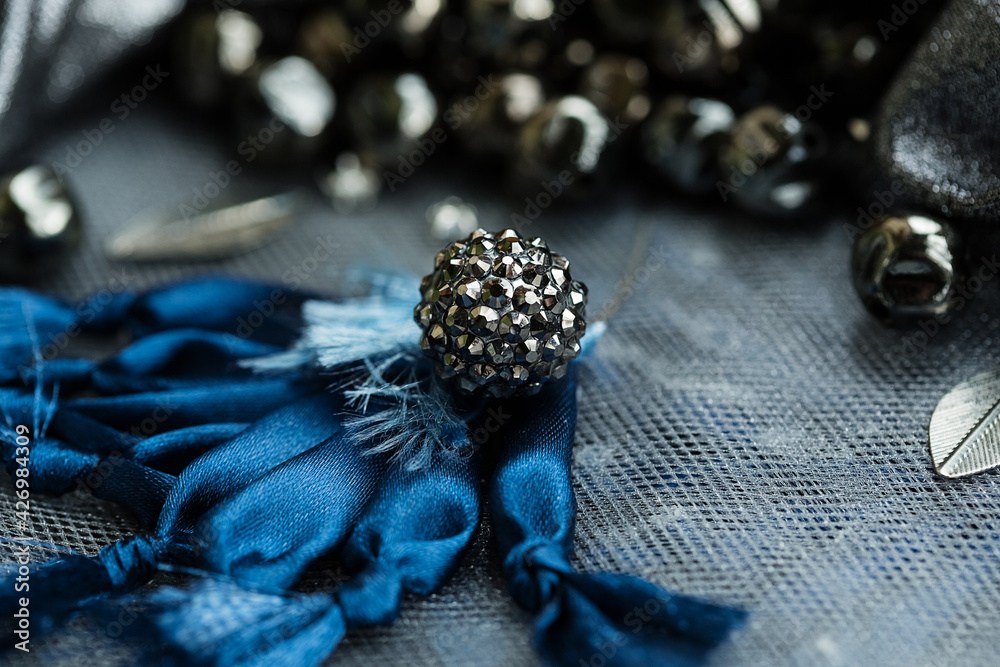 Naklejka premium Close up metal bead on large blue embroidered flower