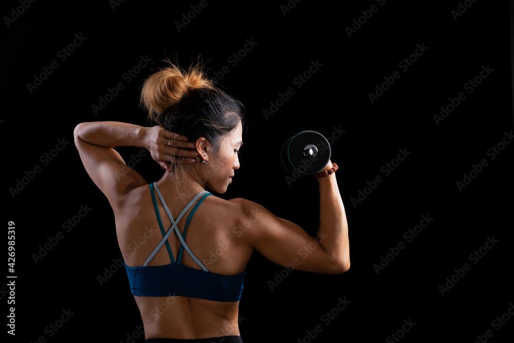 Black of ar Asian fitness woman with dumbbell doing exercises in the gym, Asian beautiful fit body with pumped muscles on black background, Fitness bikini sport athletic young women, Sporty women Black of ar Asian fitness woman with dumbbell doing exercises in the gym, Asian beautiful fit body with pumped muscles on black background, Fitness bikini sport athletic young women, Sporty women