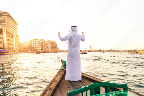 Photography Arabian man on abra boat on Creek's canal