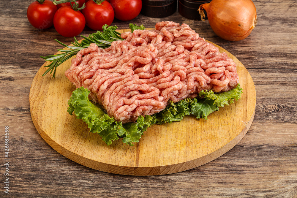 Raw pork minced meat over board Raw pork minced meat over board