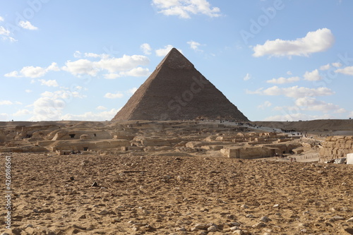 The great pyramids of giza. Tourists in the historic city. Beautiful landscape on a sunny day. View of walking people on a cloudy morning. Travel to African continent. UNESCO World Heritage Site.