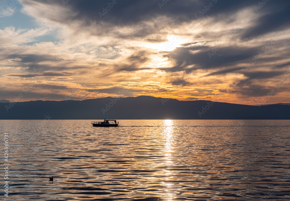 small tourist boat sails on a lake