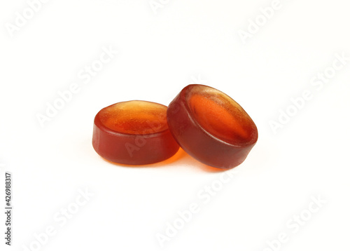 Tableau sur toile Button shaped brown gummy candies isolated on white background