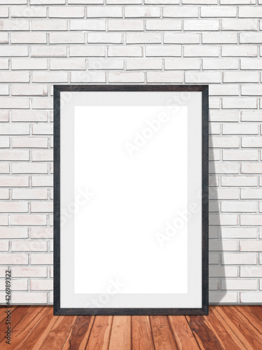 Blank frame in white brick wall with wooden floor texture interior room background  Mockup template for your content or design.