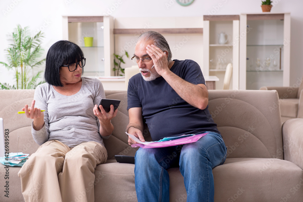 Old couple discussing family finances Old couple discussing family finances