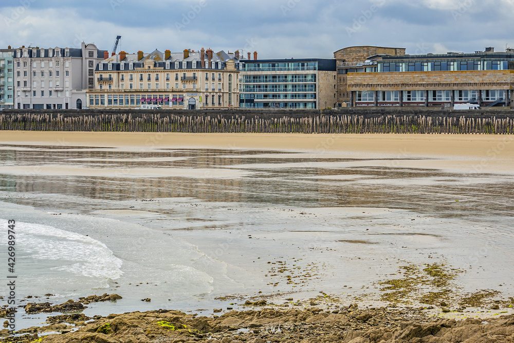 View of Saint-Malo city from Fort National at low tide. Saint-Malo is a walled port city in Brittany (prefecture Ille-et-Vilaine) in northwestern France on English Channel.