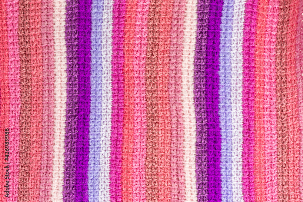 striped background of tunisian crochet fabric in basic stitch in shades of pink and purple striped background of tunisian crochet fabric in basic stitch in shades of pink and purple