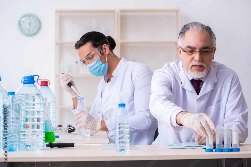 Two chemists working in the lab Two chemists working in the lab