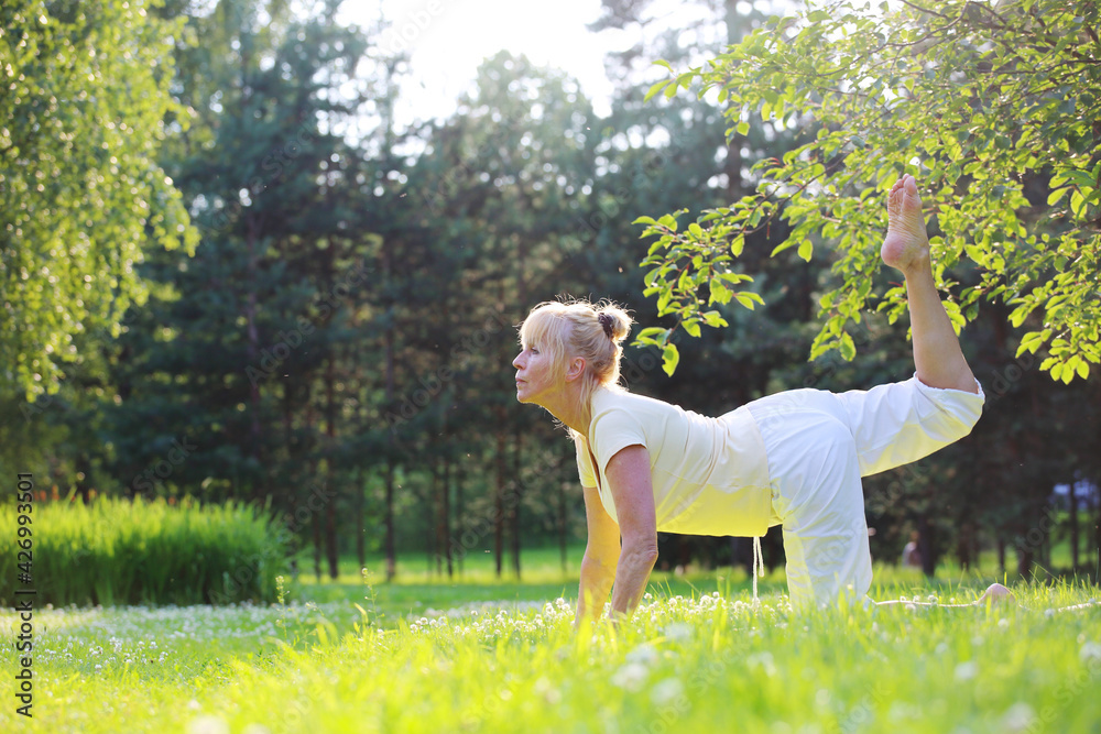 Naklejka premium Yoga woman in park