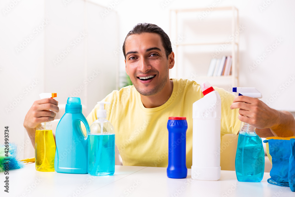 Young male contractor doing housework at home Young male contractor doing housework at home
