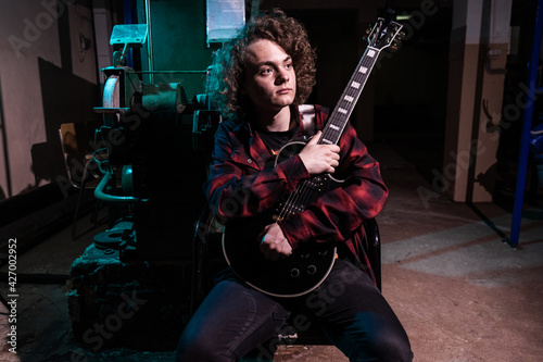 portrait of a musician. Handsome young man with musical instruments.