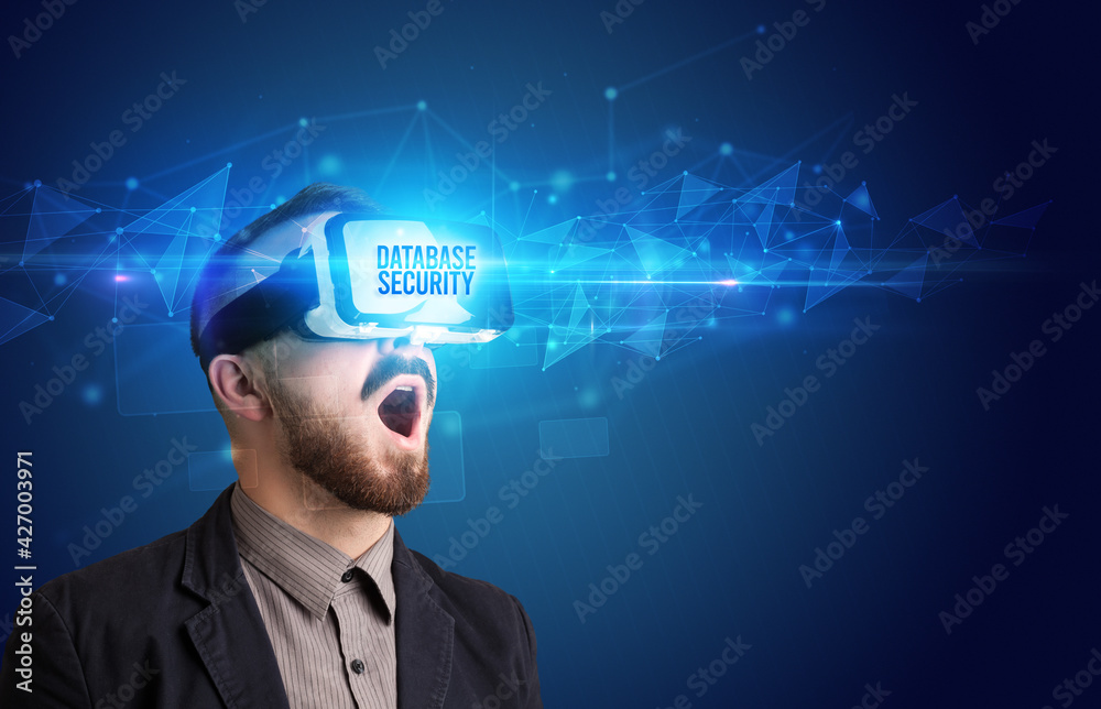 Businessman looking through Virtual Reality glasses, virtual security concept Businessman looking through Virtual Reality glasses, virtual security concept