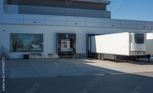 trucks at loading ramps of a warehouse