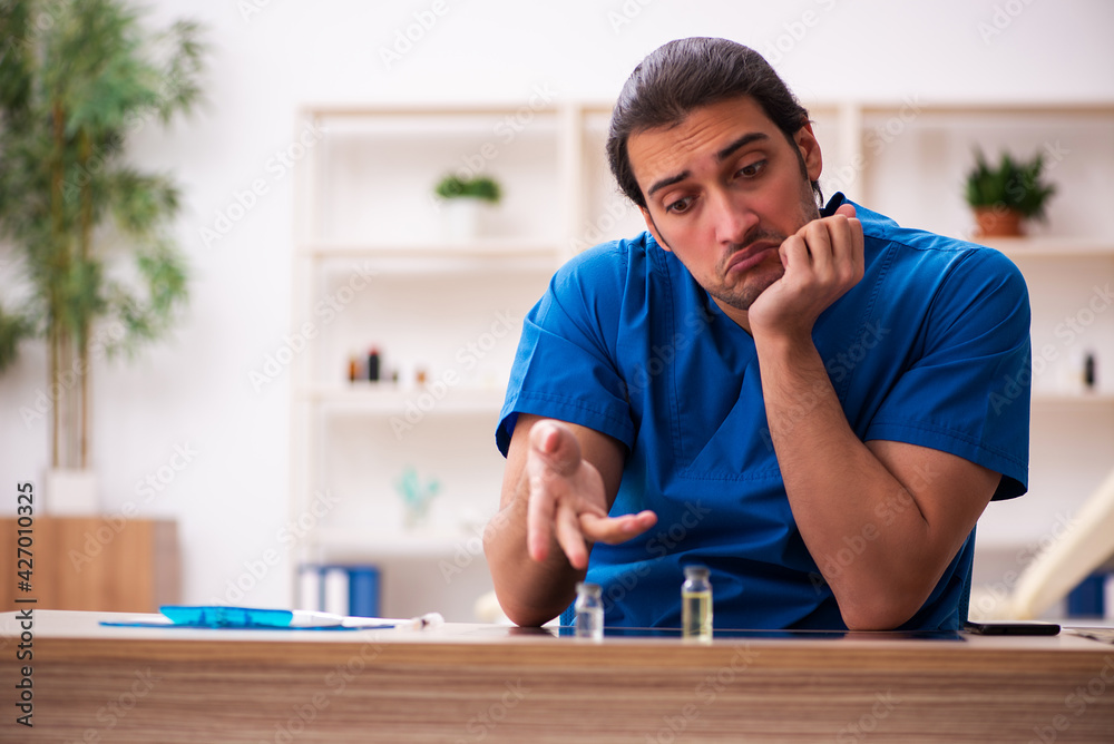 Fototapeta premium Young male doctor in vaccination concept