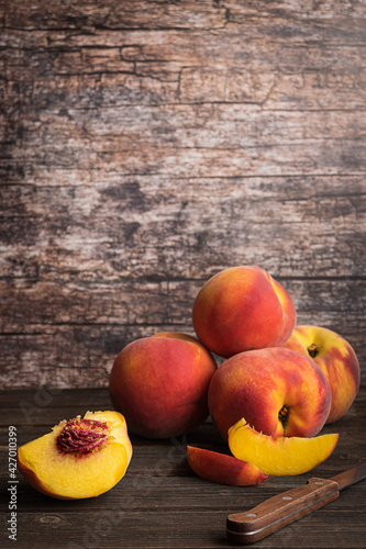Fresh juicy peaches on dark rustic background. Copy space.