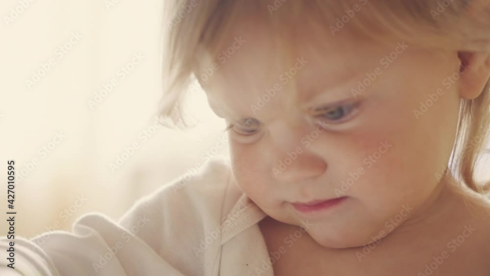 new technologies, a child carefully looks into an electronic tablet, a close-up of a face is shot new technologies, a child carefully looks into an electronic tablet, a close-up of a face is shot