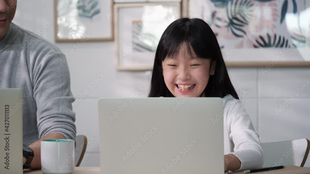 Asian family of businessman working and student girl studying from home. Father and Daughter happy expression with conference online in internet while being quarantine at home. Stay at home family. Asian family of businessman working and student girl studying from home. Father and Daughter happy expression with conference online in internet while being quarantine at home. Stay at home family.