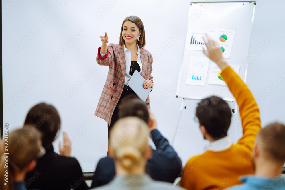 Young woman coach speaker giving flipchart presentation, speaker leading training, mentor leader explain strategy schedule at team meeting. Planning, analysis, collaborate work in teamwork. - obrazy, fototapety, plakaty 