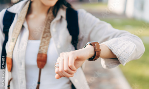 Close up hand woman people wear smart watch checking time and health information at outdoor.