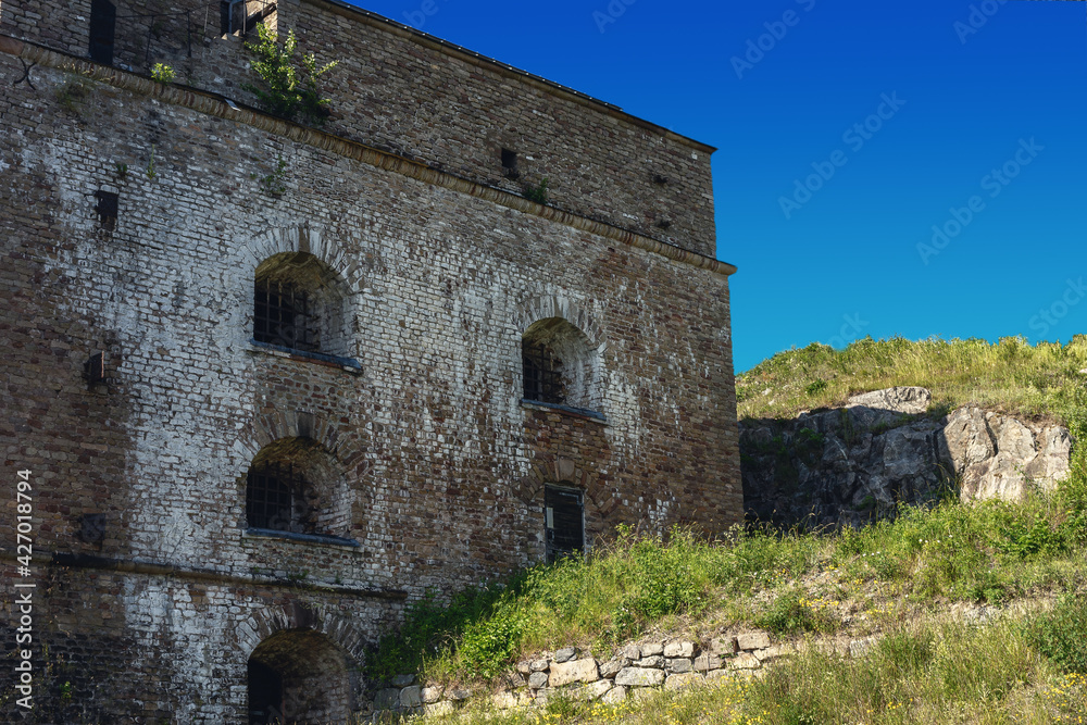 The old building stands on a hill against the blue sky. The old building stands on a hill against the blue sky.