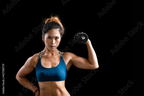 Muscular Asian fitness woman with dumbbell doing exercises in the gym, Asian beautiful fit body with pumped muscles on black background, Fitness bikini sport athletic young women, Sporty women
