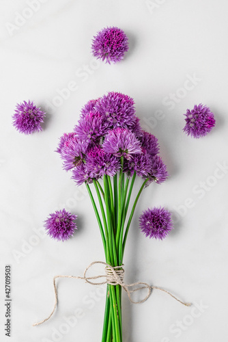 Fototapeta Naklejka Na Ścianę i Meble -  Purple alium flowers bouquet on white background. top view. flat lay. vertical orientation