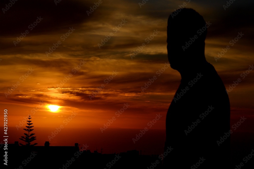 a silhouette of a young boy and a sunset in Tenerife