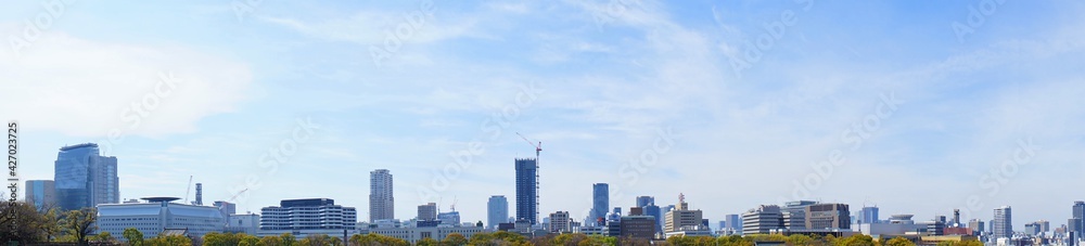 City landscape of Osaka, Japan from Osaka castle park.  Panoramic view during spring. - 大阪の都市景観 大阪城公園から