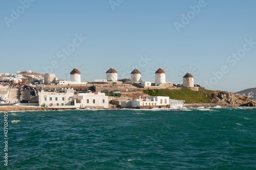 Panoramic view from the sea of the windmills on the island of Mykonos in Greece, Cyclades Islands. Tourism travel concept