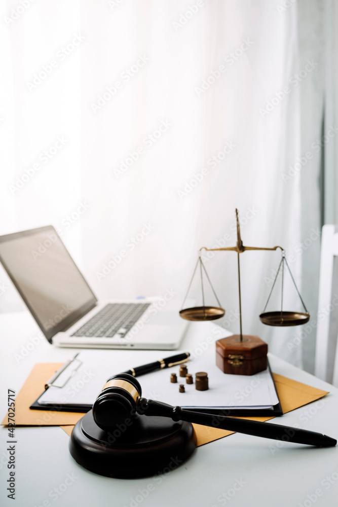 justice and law concept.Male judge in a courtroom on wooden table and Counselor or Male lawyer working in office. Legal law, advice and justice concept.