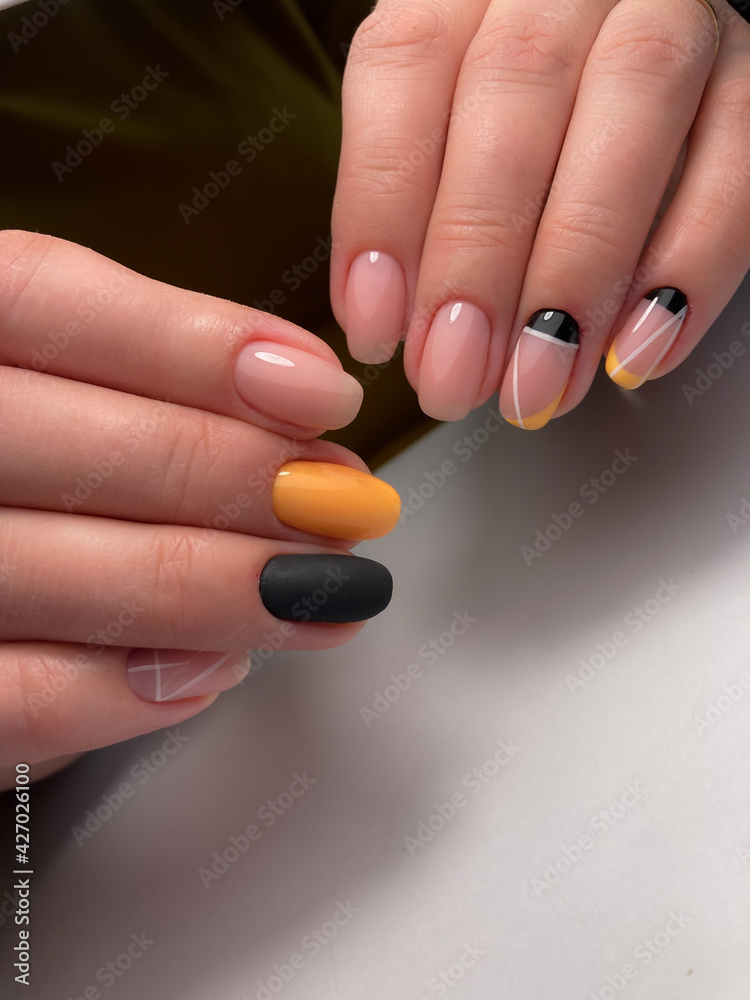 The work of a manicure master. Hands of a beautiful young woman and modern design. The work of a manicure master. Hands of a beautiful young woman and modern design.