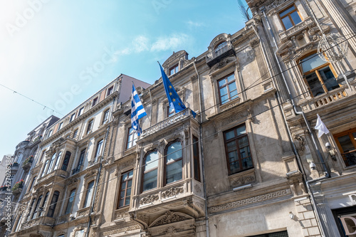Canvas-taulu low angle view of Greek and European Union flags on historical building of Greec
