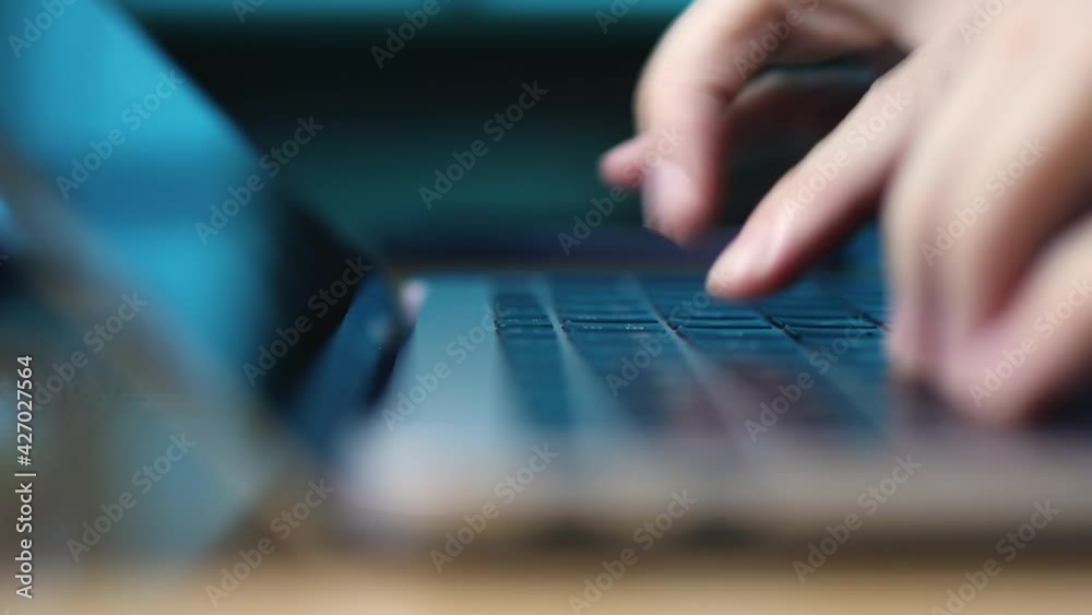 Selective focus typing on computer keyboard. Fingers of person during using laptop at night. Selective focus typing on computer keyboard. Fingers of person during using laptop at night.