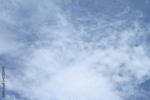 Beautiful blue sky and white clouds of various shapes with sunlight Nature background