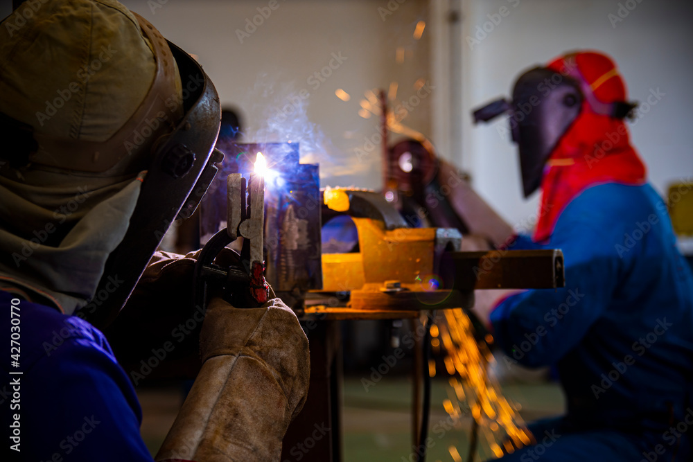 Welder is assembling the workpiece by process shielded metal arc