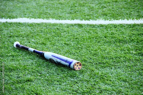 baseball bat on the grass near the line of the playing field