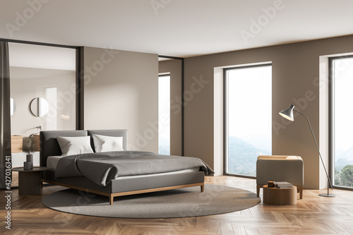 Modern cozy bedroom interior with large comfortable grey bed © ImageFlow