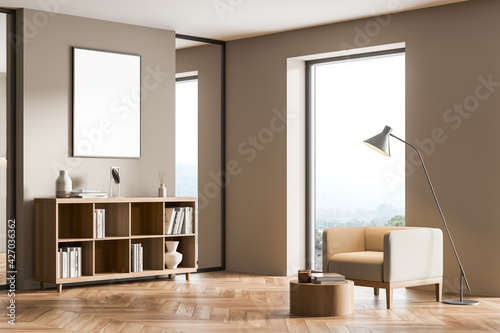 Living room interior with comfortable armchair and empty poster