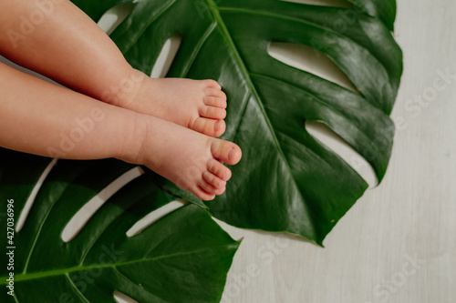 children's feet on the sheets of monsters and wooden floor