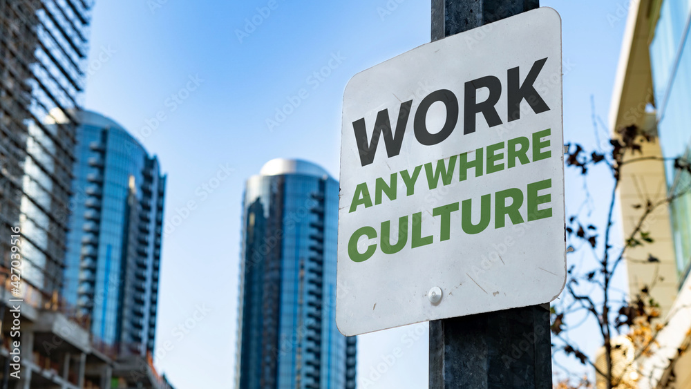 Work Anywhere Culture on Worn Sign in Downtown city setting