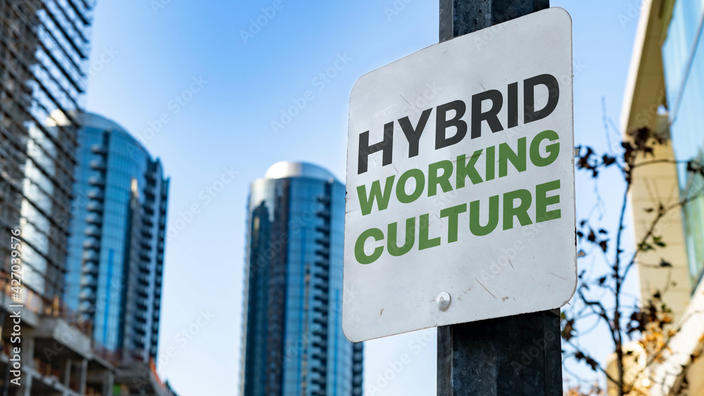 Hybrid Working Culture on Worn Sign in Downtown city setting Hybrid Working Culture on Worn Sign in Downtown city setting