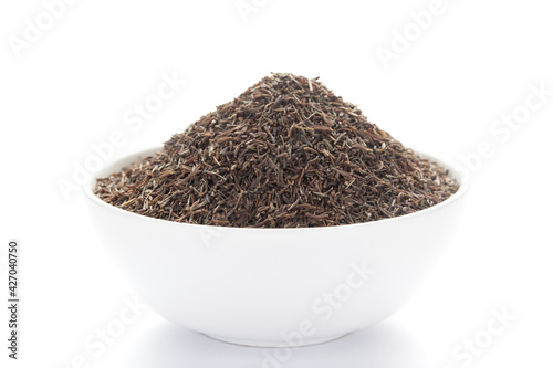 close-up of Organic Black Cumin (Elwendia persica) or black caraway or Kala jeera on a ceramic white bowl. Pile of Indian Aromatic Spice. 