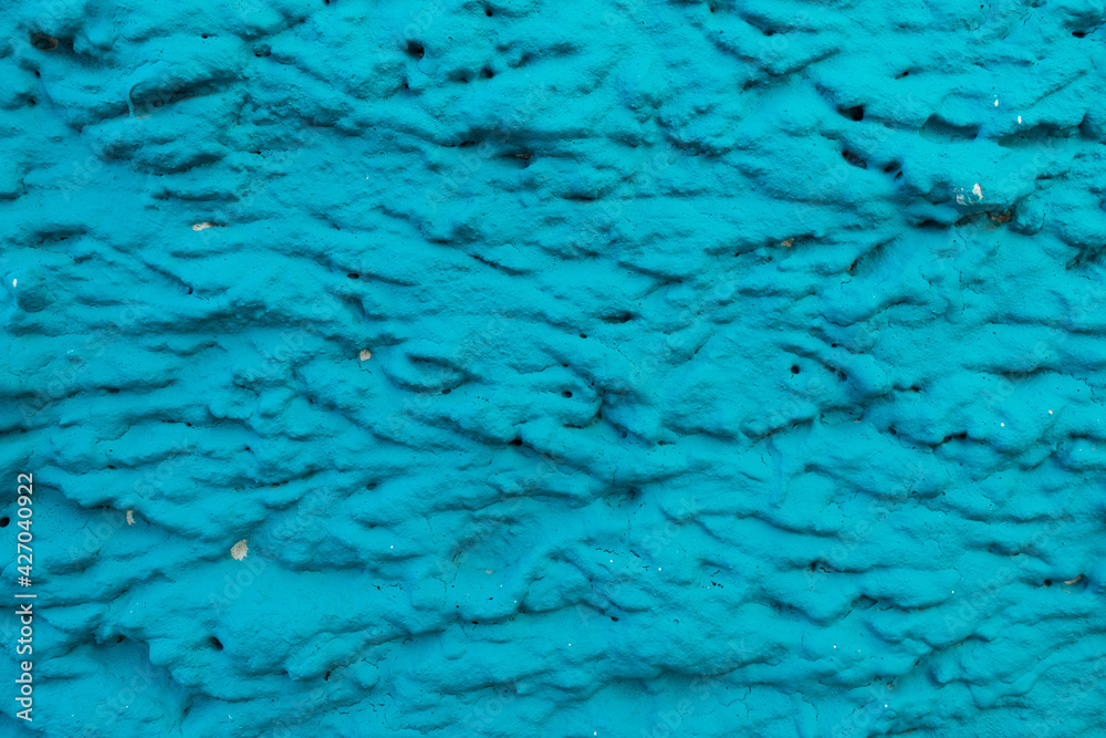 Close-up of the facade of the building with blue plaster Close-up of the facade of the building with blue plaster