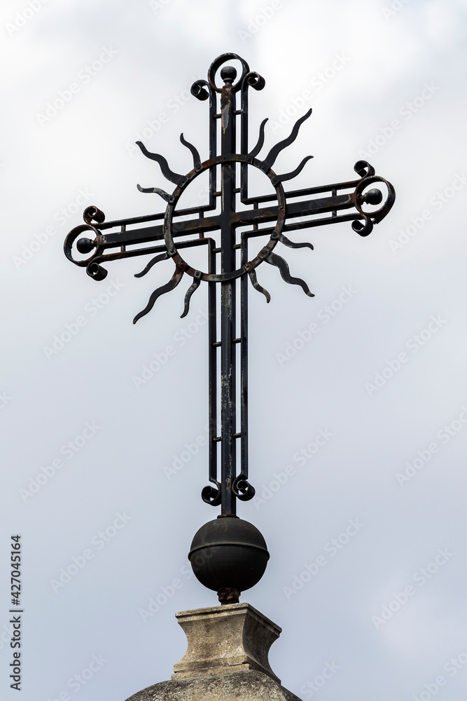 Christian metal cross on sky background.