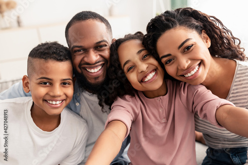 Portrait of african american family taking a selfie together at home photo