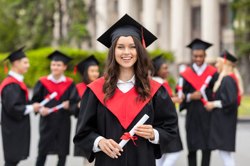 Cheerful young woman student having graduation party