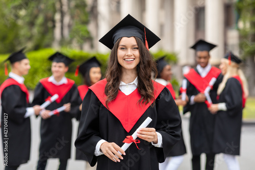 Cheerful young woman student having graduation party photo