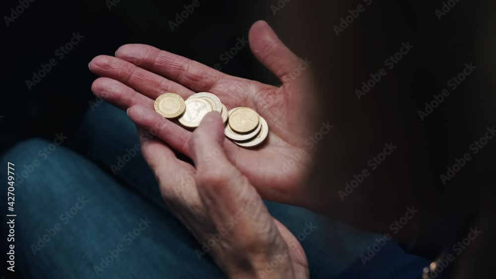 Old woman counting coins in her wrinkled hands. Close up. High quality 4k footage Old woman counting coins in her wrinkled hands. Close up. High quality 4k footage