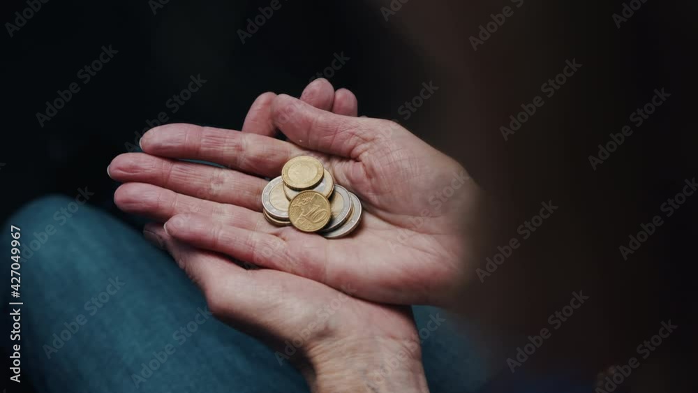 Insuficient funds concept. Poor old woman opening hand with coins. High quality 4k footage Insuficient funds concept. Poor old woman opening hand with coins. High quality 4k footage