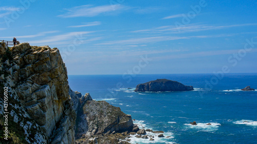 People enjoying the view at the northern coats of Spain. The northern Spanish coastline is rugged and beautiful, with constant punishment of the waves you get one of the wildest places on earth.